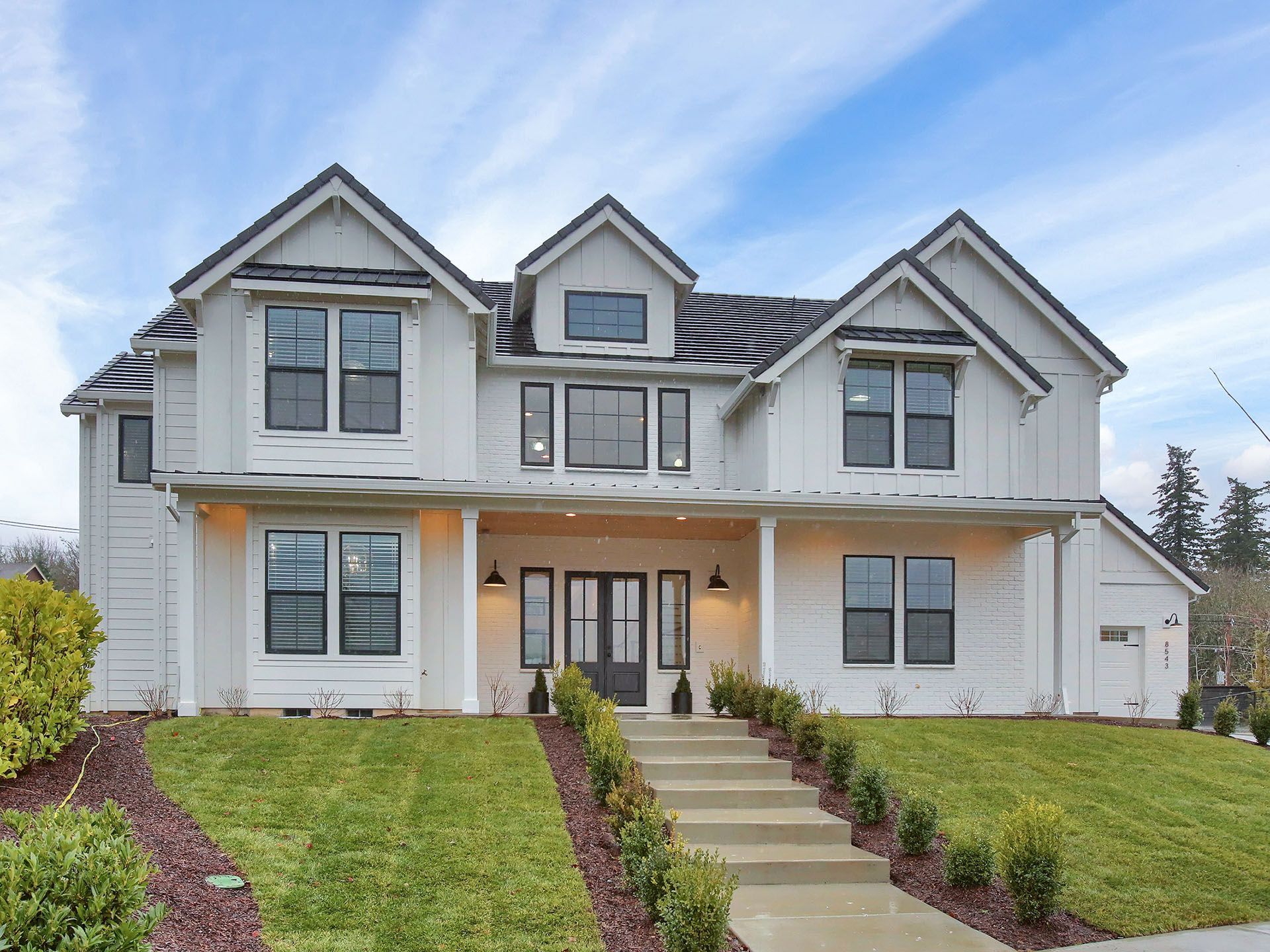 A large white house with stairs leading up to it