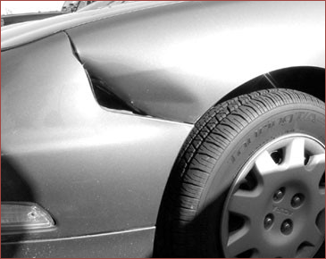 Dented sheet metal on the side of th ecar damaged in crash accident.