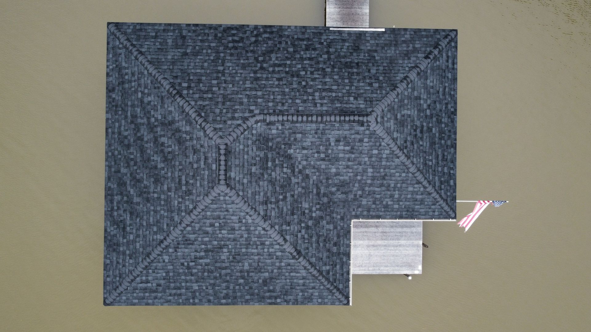 Blue-gray quilted square fabric with a small white tag on a beige background