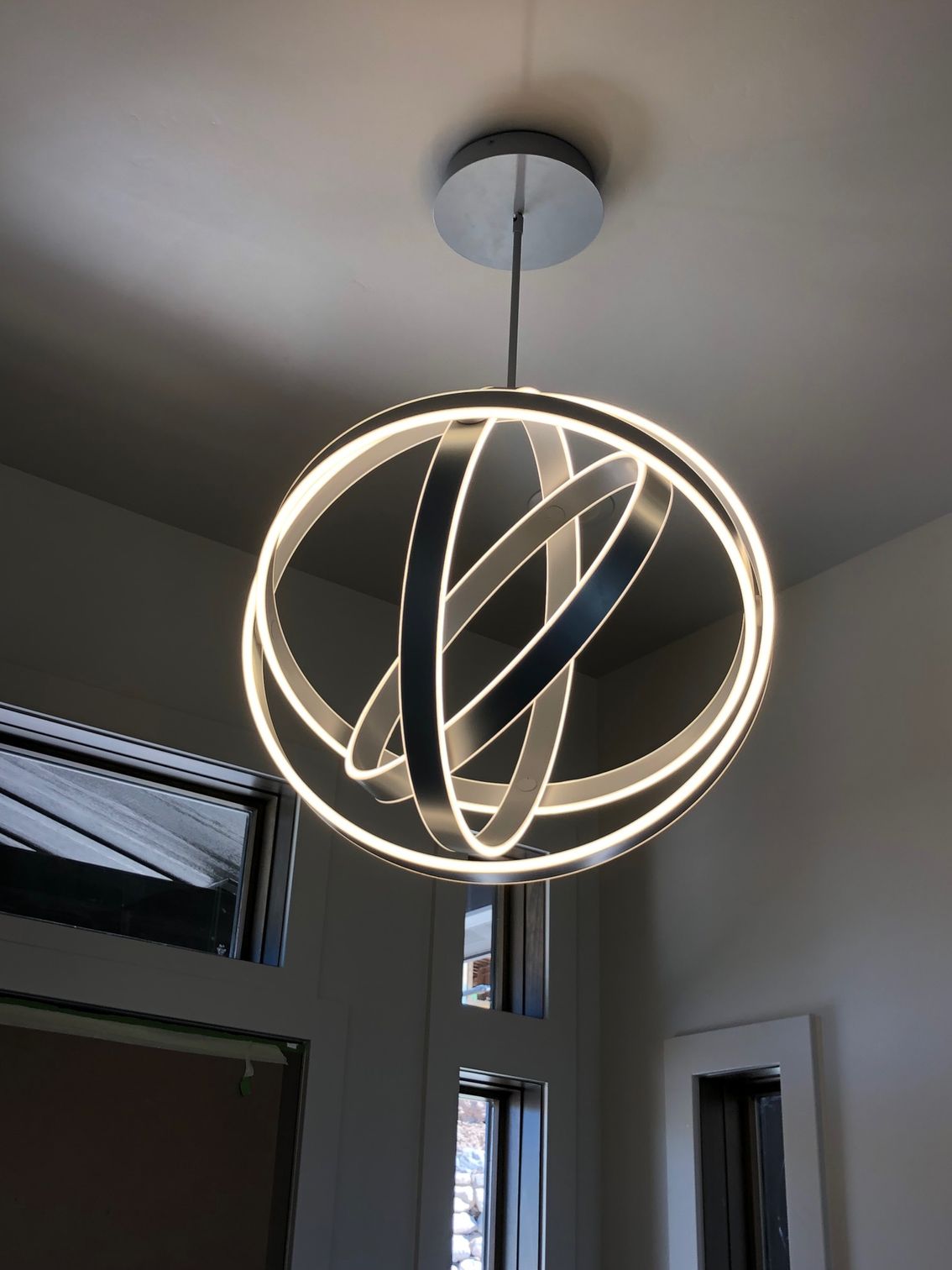 A light fixture is hanging from the ceiling in a room