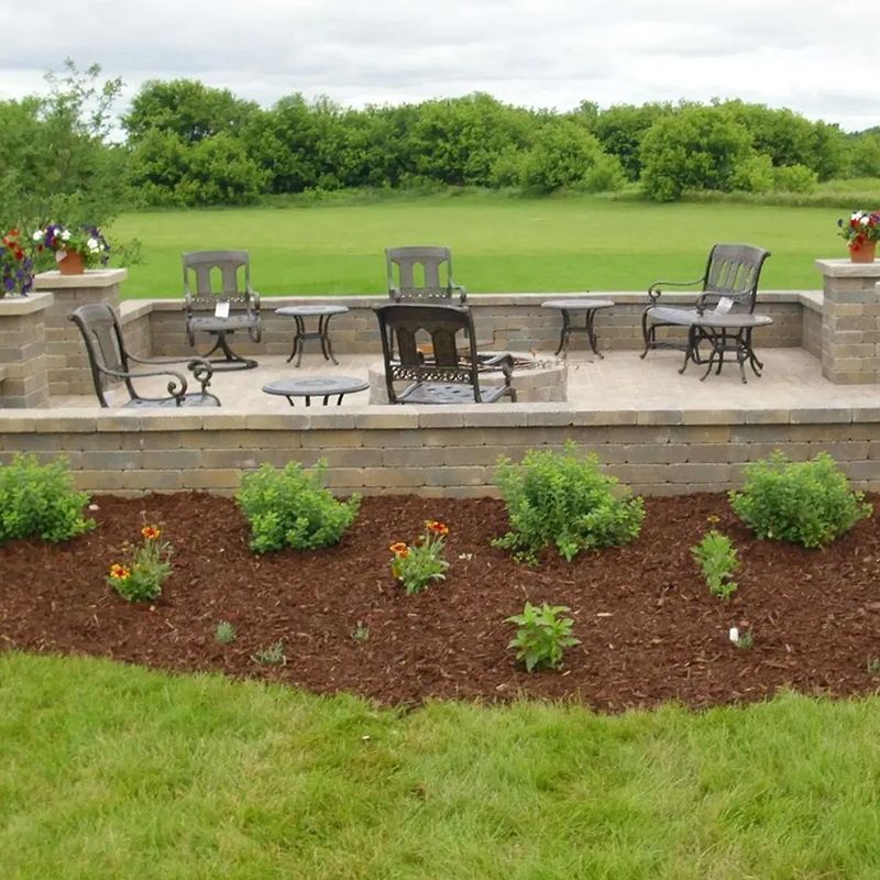 A patio area with tables and chairs and a fire pit