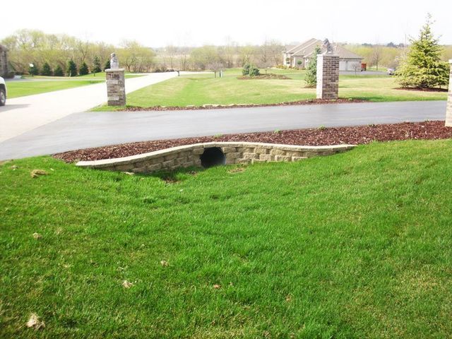 a house with a lush green lawn and a driveway