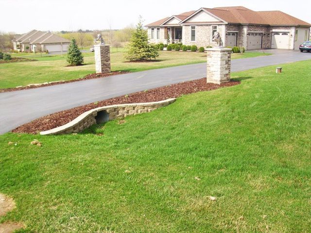 a house with a lush green lawn and a driveway