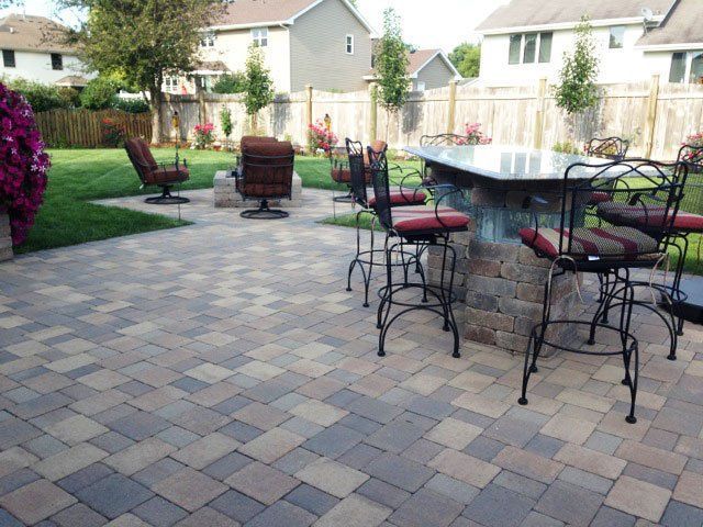 a patio with a table and chairs on it