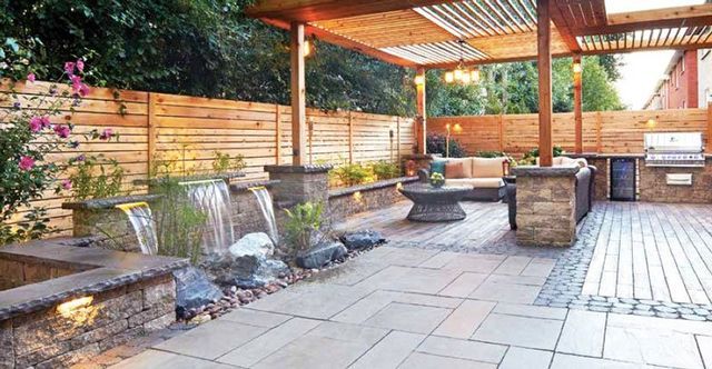 there is a waterfall in the middle of the backyard .