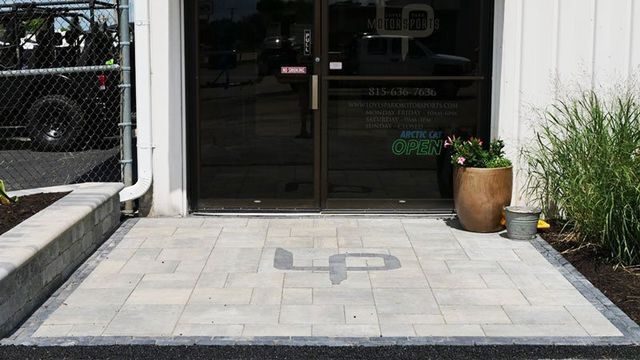 a brick walkway leading to the entrance of a building .