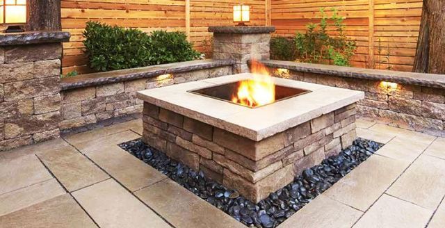 there is a fire pit in the middle of the patio .