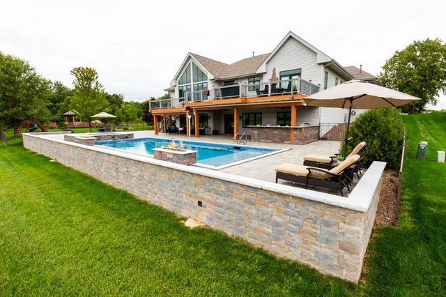 a large house with a large swimming pool in the backyard .
