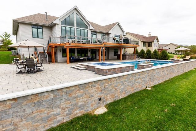 a large house with a large swimming pool and patio .