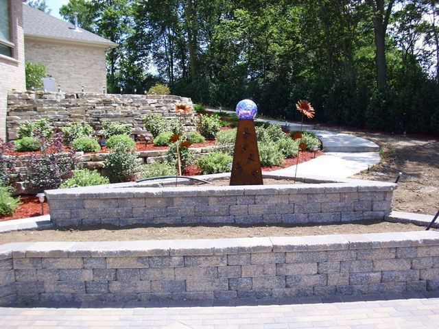 a brick wall with a sculpture in the middle of it