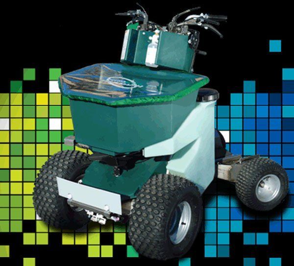 a green lawn mower is sitting on a black background