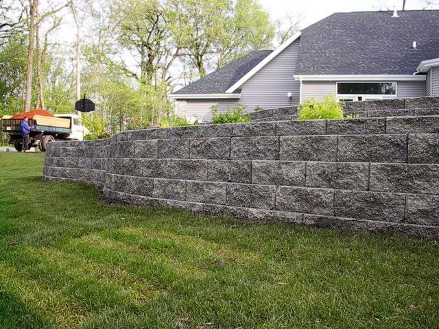 a brick wall is being built in front of a house .