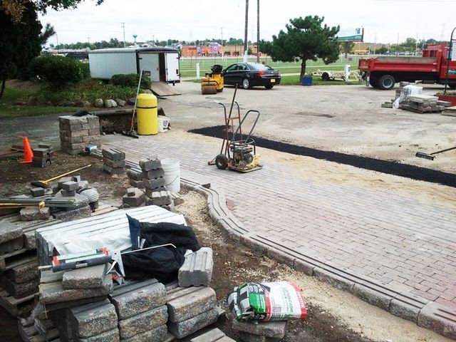 a brick walkway is being built in a parking lot