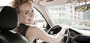 Smiling lady driving a car