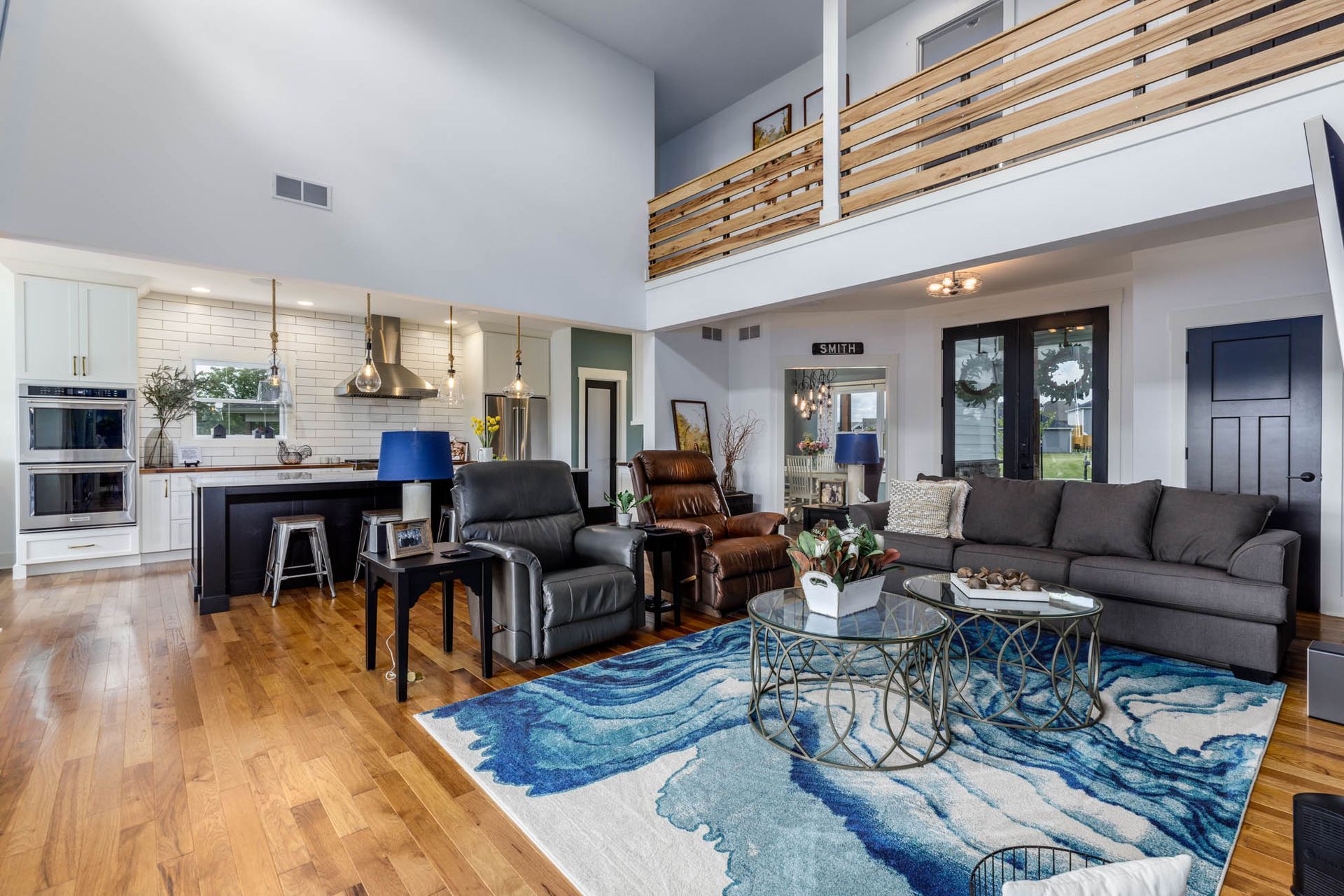 A living room filled with furniture and a blue rug