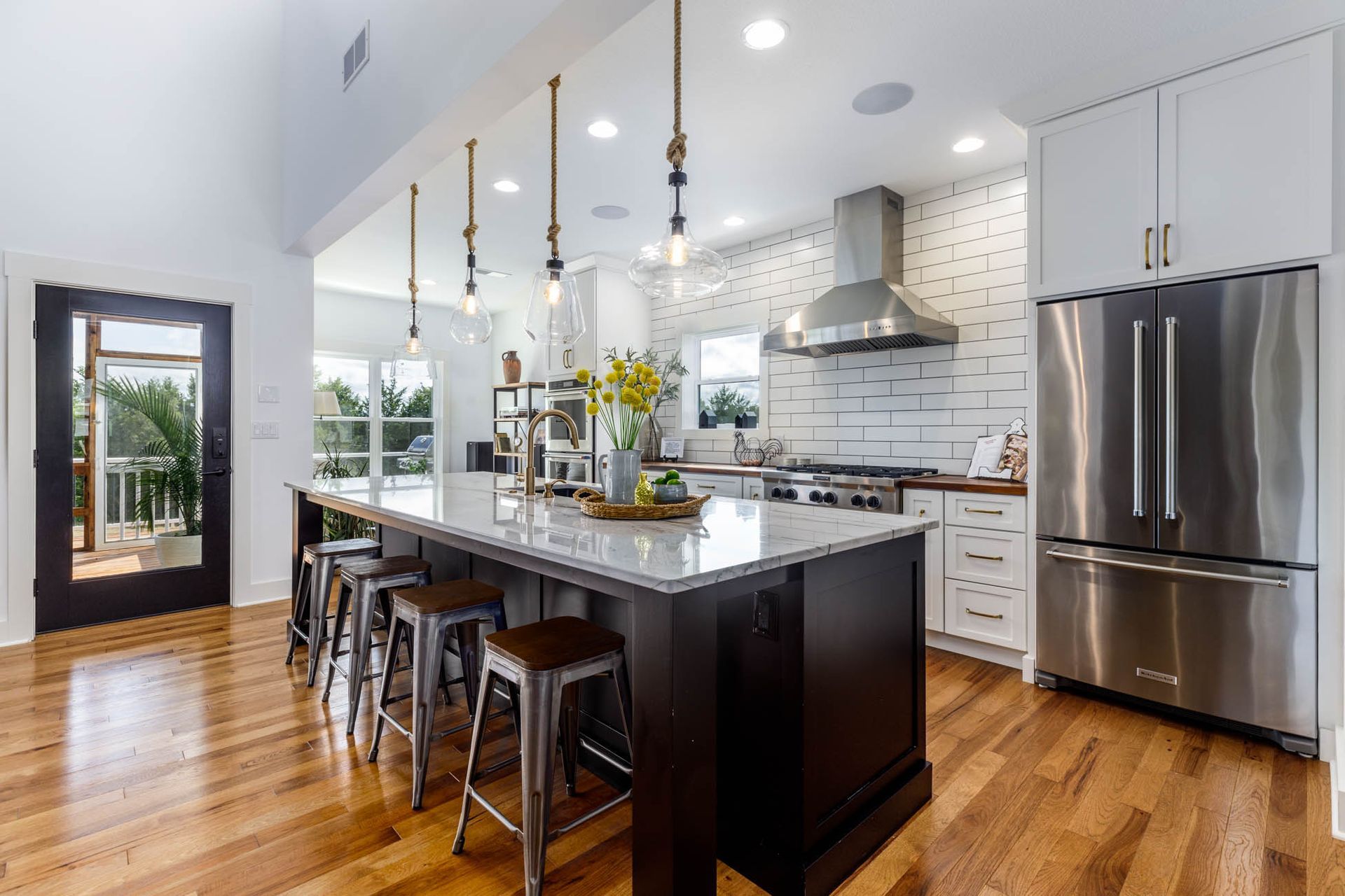 A kitchen with stainless steel appliances and a large island