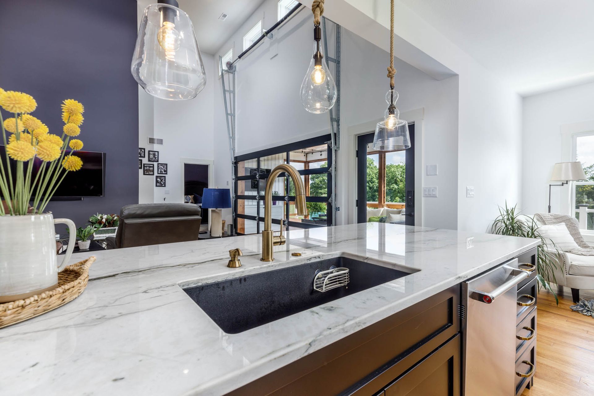 A kitchen with a sink, faucet, and dishwasher