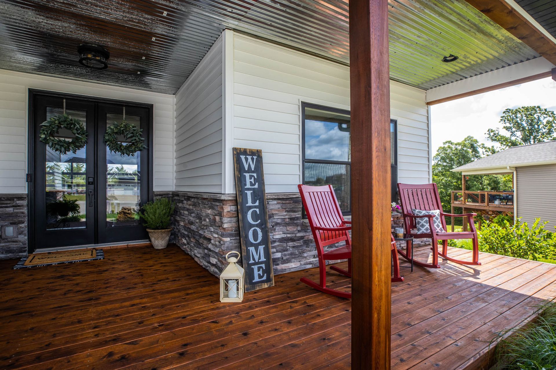 There is a welcome sign on the porch of a house