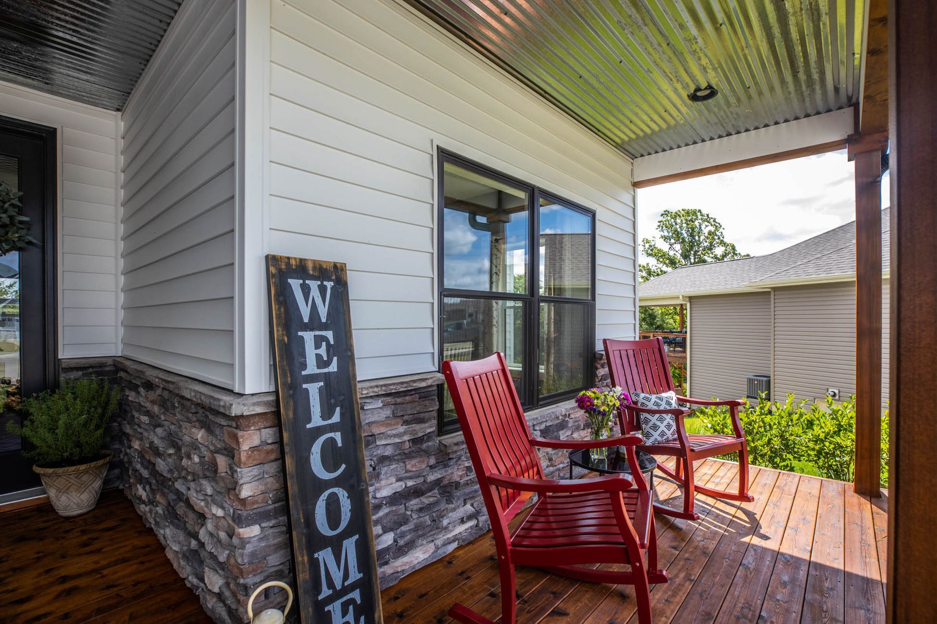 There is a welcome sign on the porch of a house