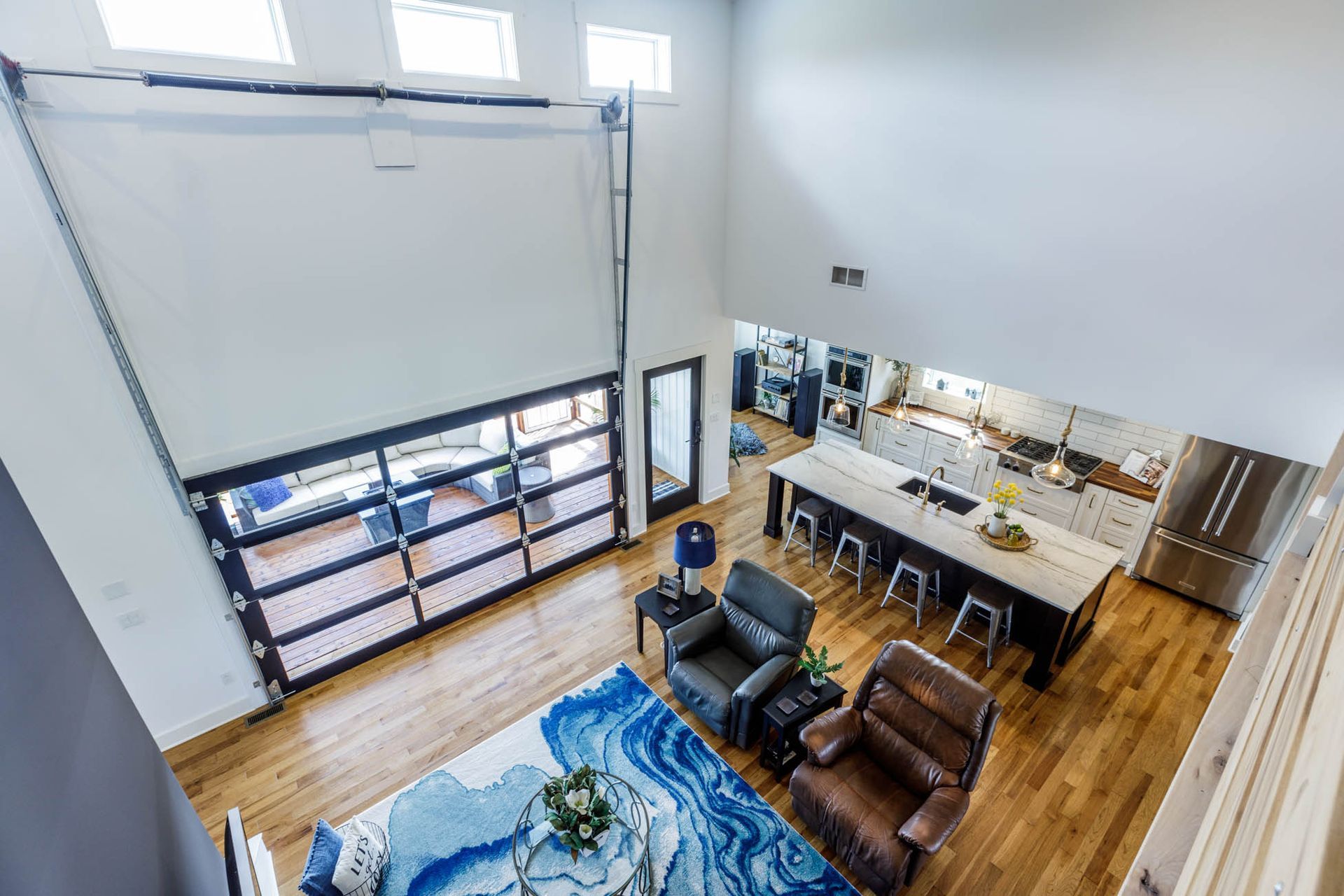 An aerial view of a living room and kitchen in a house