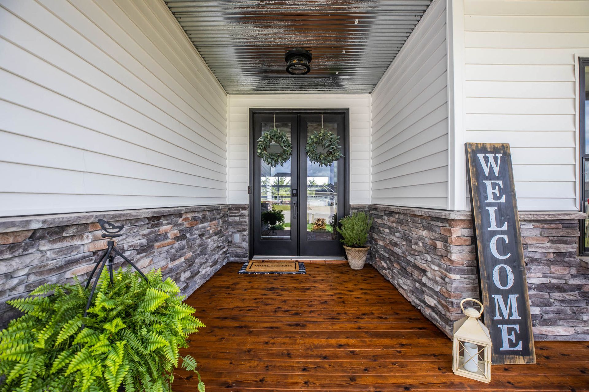 There is a welcome sign on the porch of a house