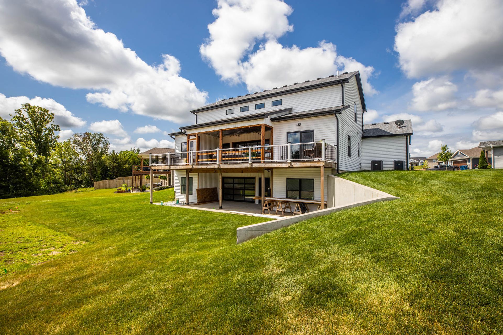 A large white house with a large lawn in front of it