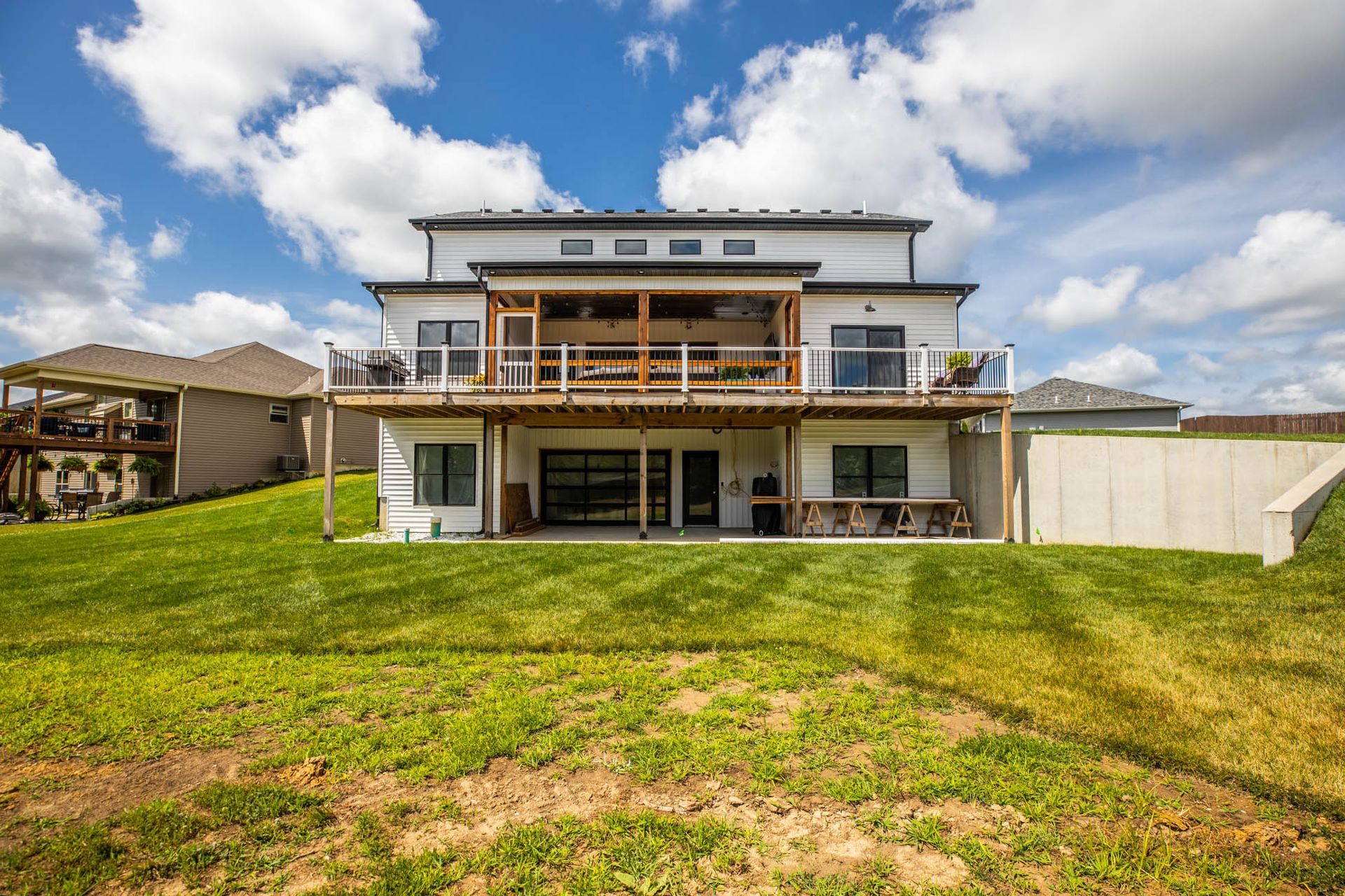 The back of a house with a large lawn in front of it