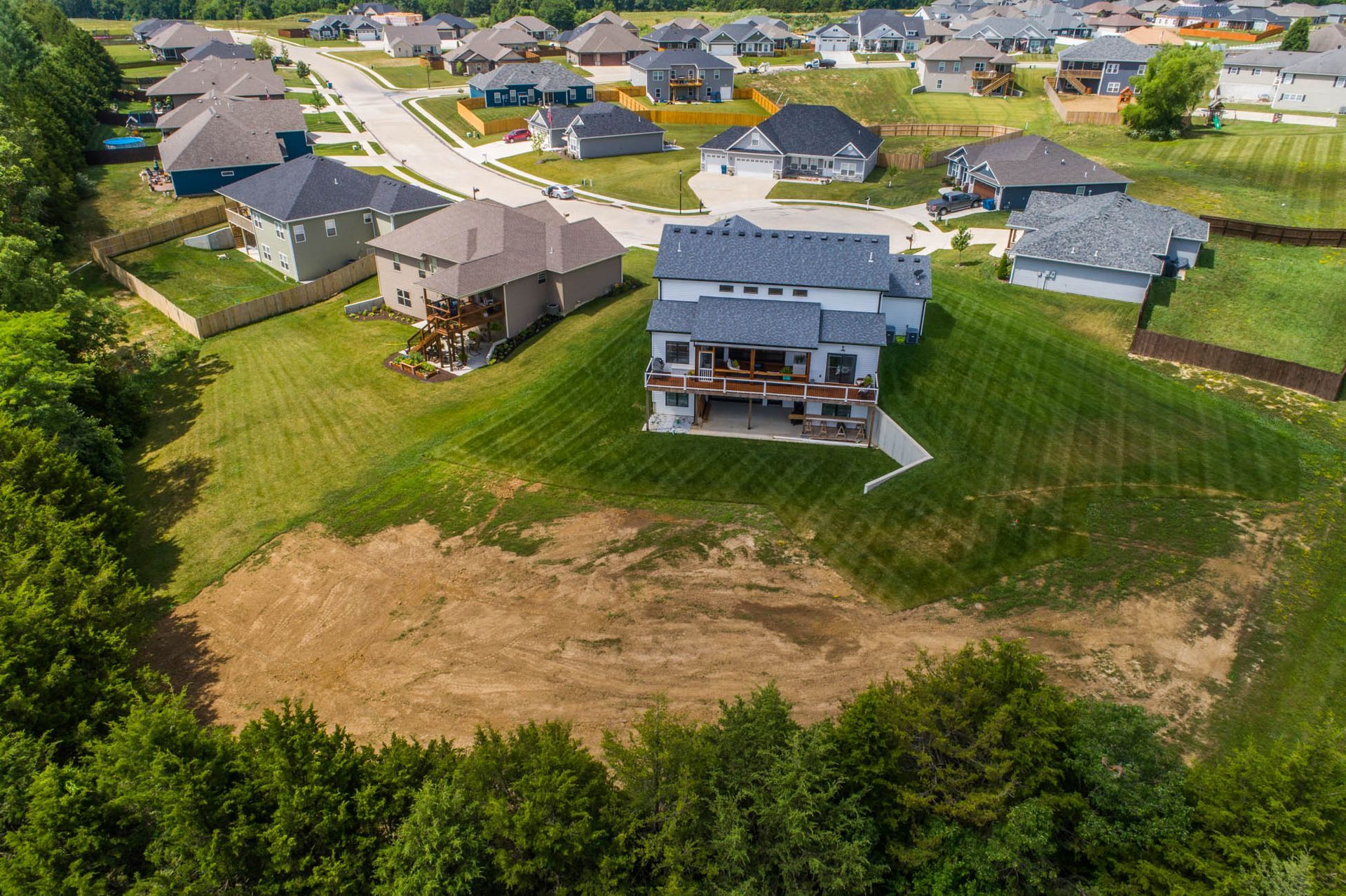 An aerial view of a residential area with lots of houses and trees