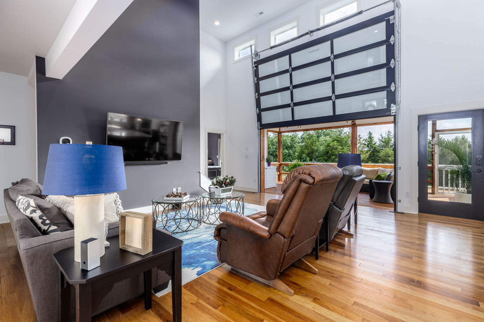 A living room filled with furniture and a large garage door