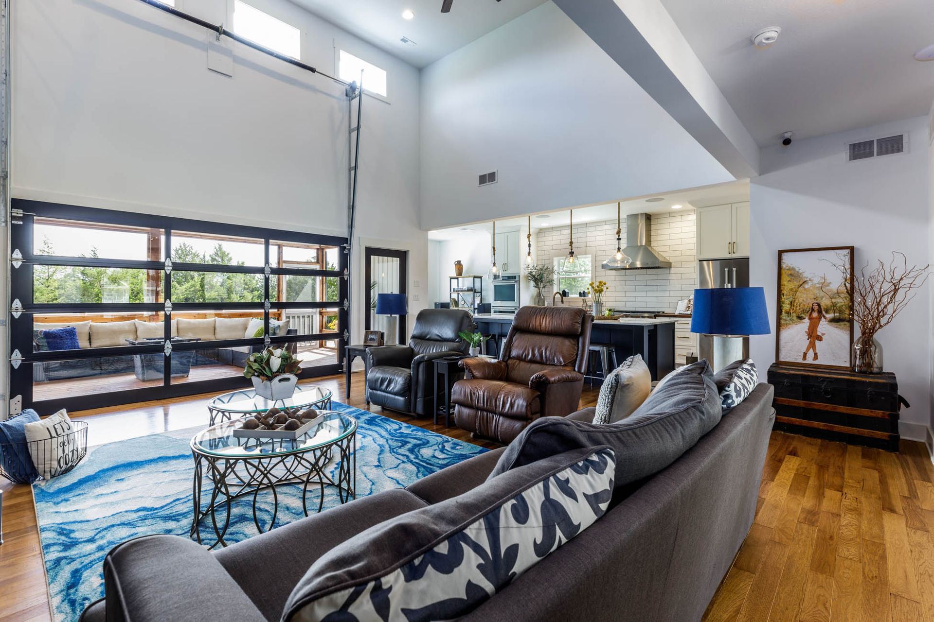 A living room with a couch, chairs, and a table