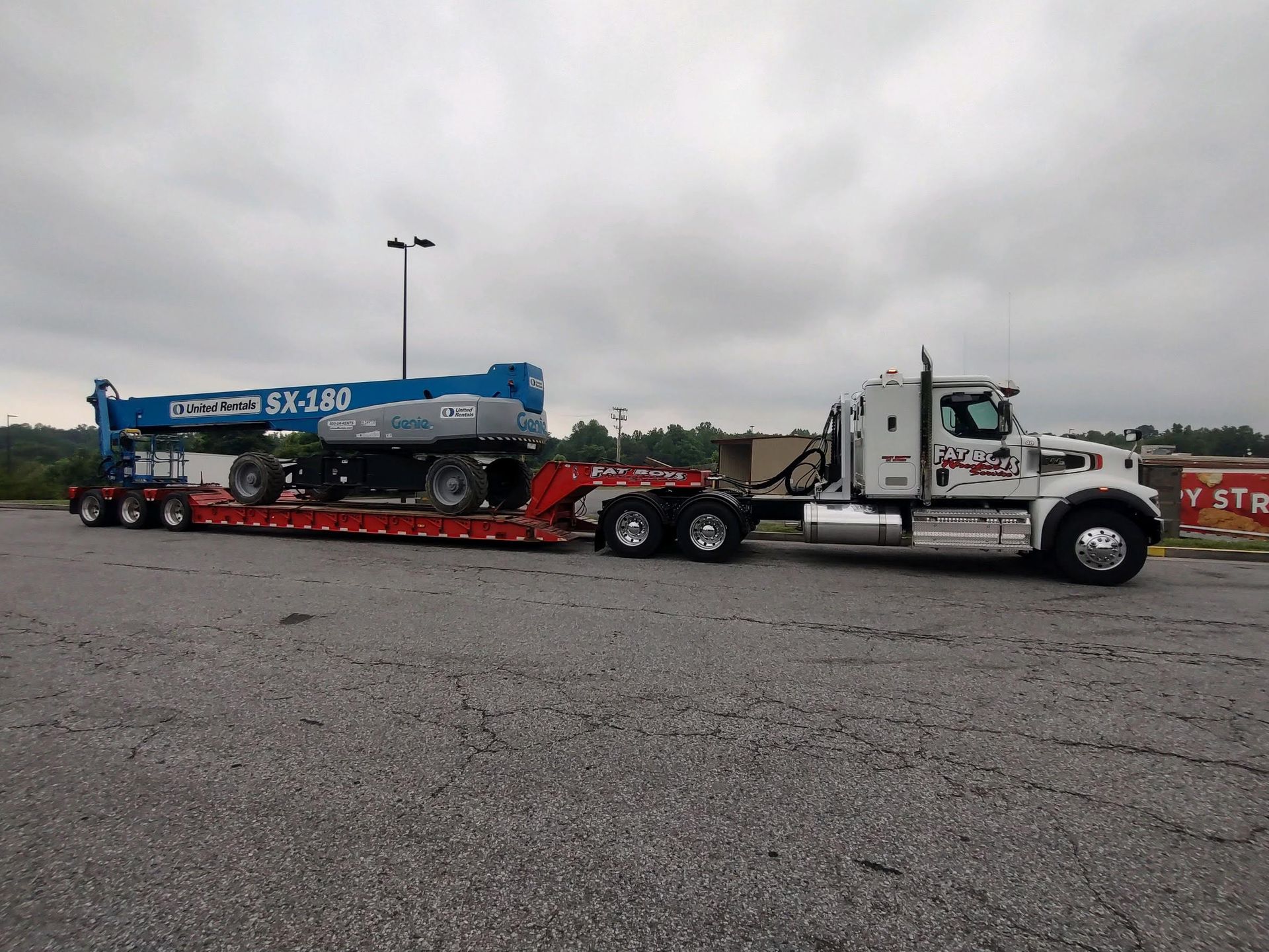A semi truck with a crane on the back of it