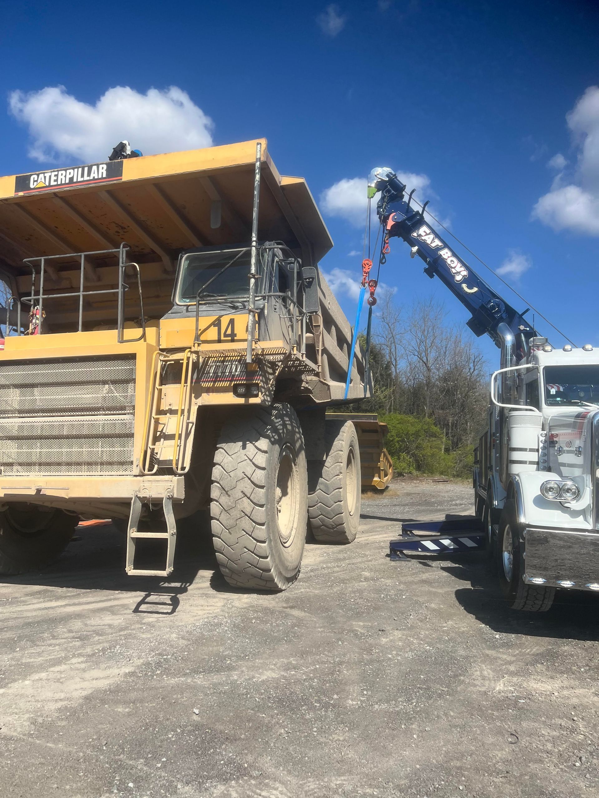 A large yellow dump truck with the number 14 on it