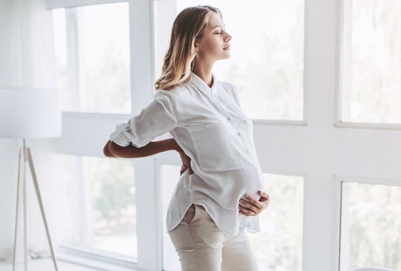 Pregnant woman standing near the window