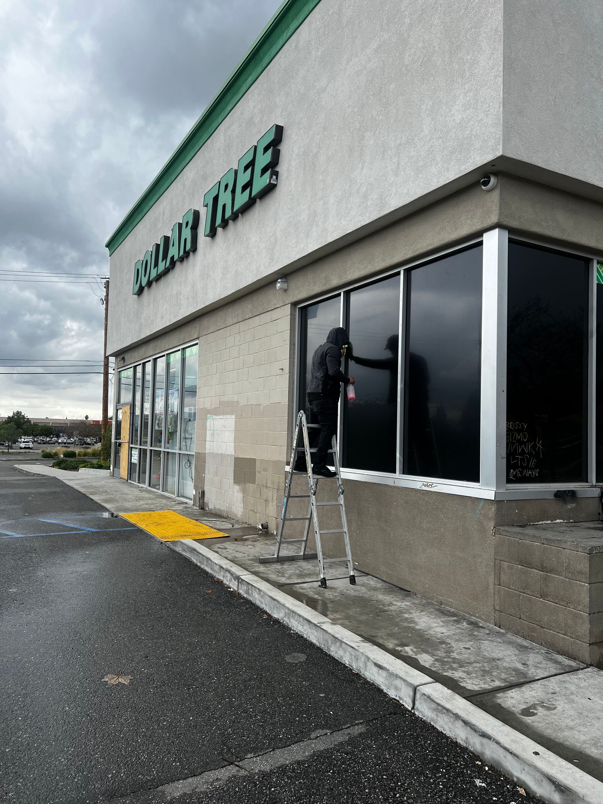 Storefront with ladder under the windows on a cloudy day