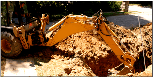 Yellow tractor excavating