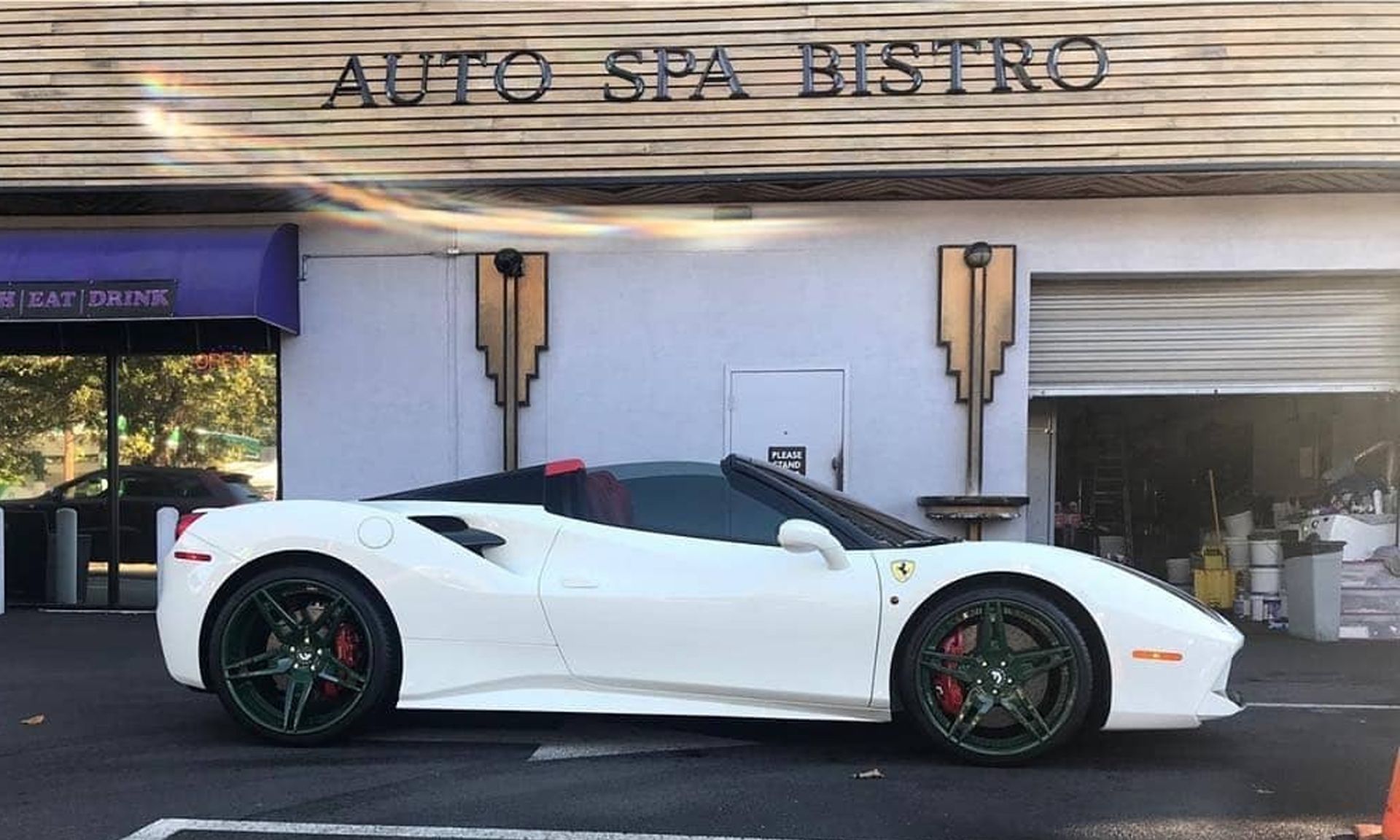 White Ferrari convertible parked outside 