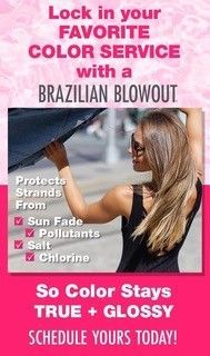 A woman is holding an umbrella over her head.