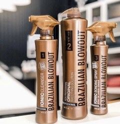 Three bottles of brazilian blowout products are sitting on a table.