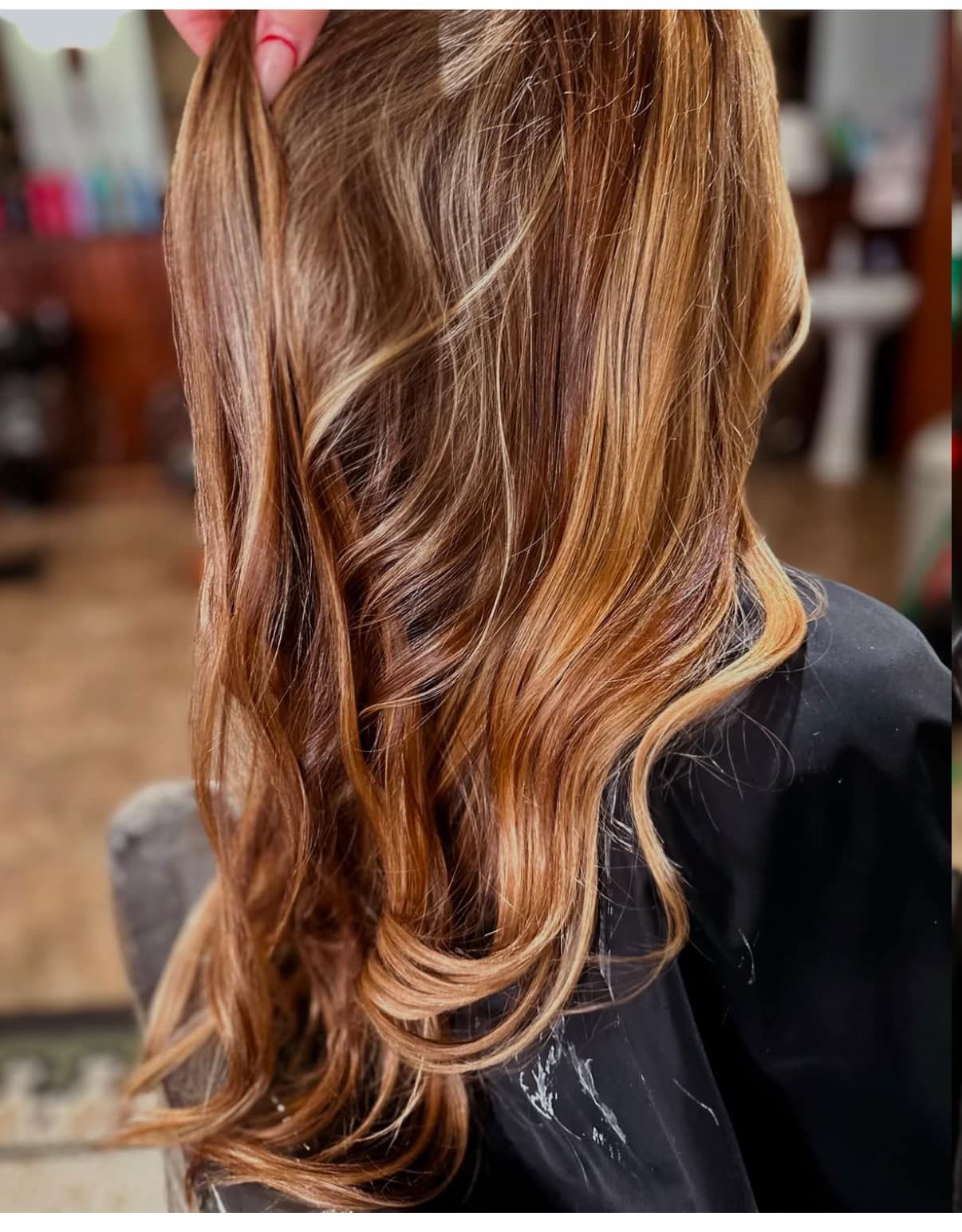 A woman is getting her hair done at a salon