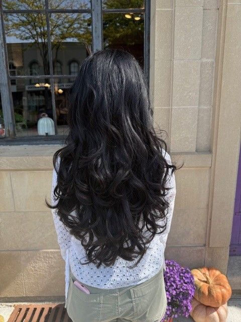 Woman with long, black, wavy hair