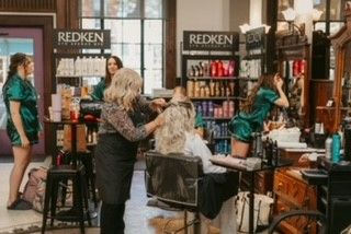 A woman is getting her hair done in a salon.