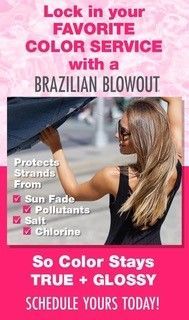 A woman is holding an umbrella over her head.