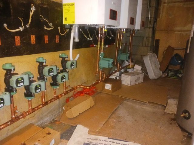 A room with a lot of pipes and a sign that says ' a ' on it