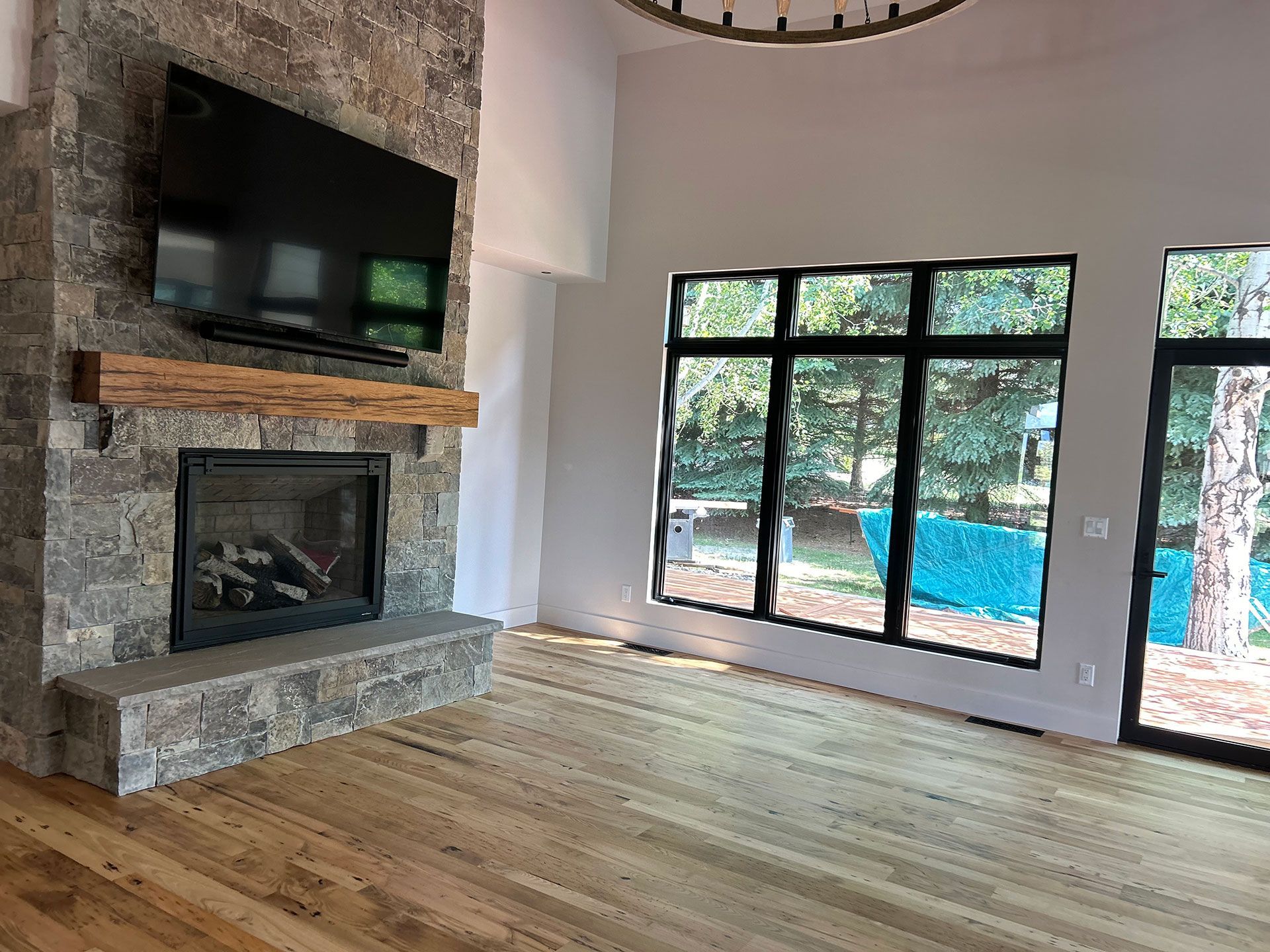 A living room with a fireplace and a flat screen tv