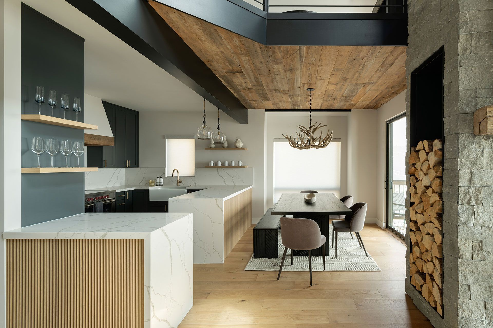 A kitchen and dining room in a house with a wooden ceiling