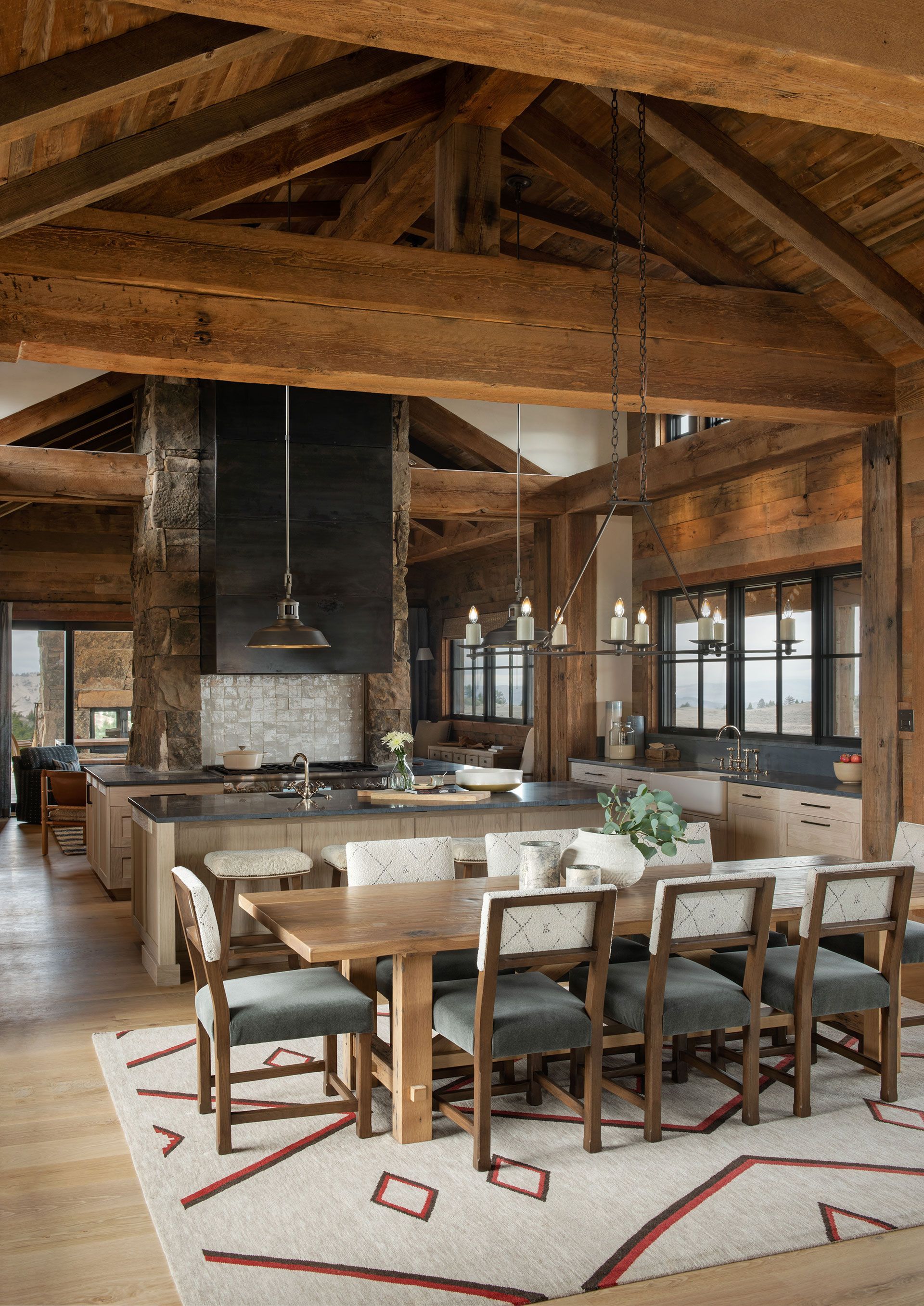 A kitchen and dining room in a house with wooden beams