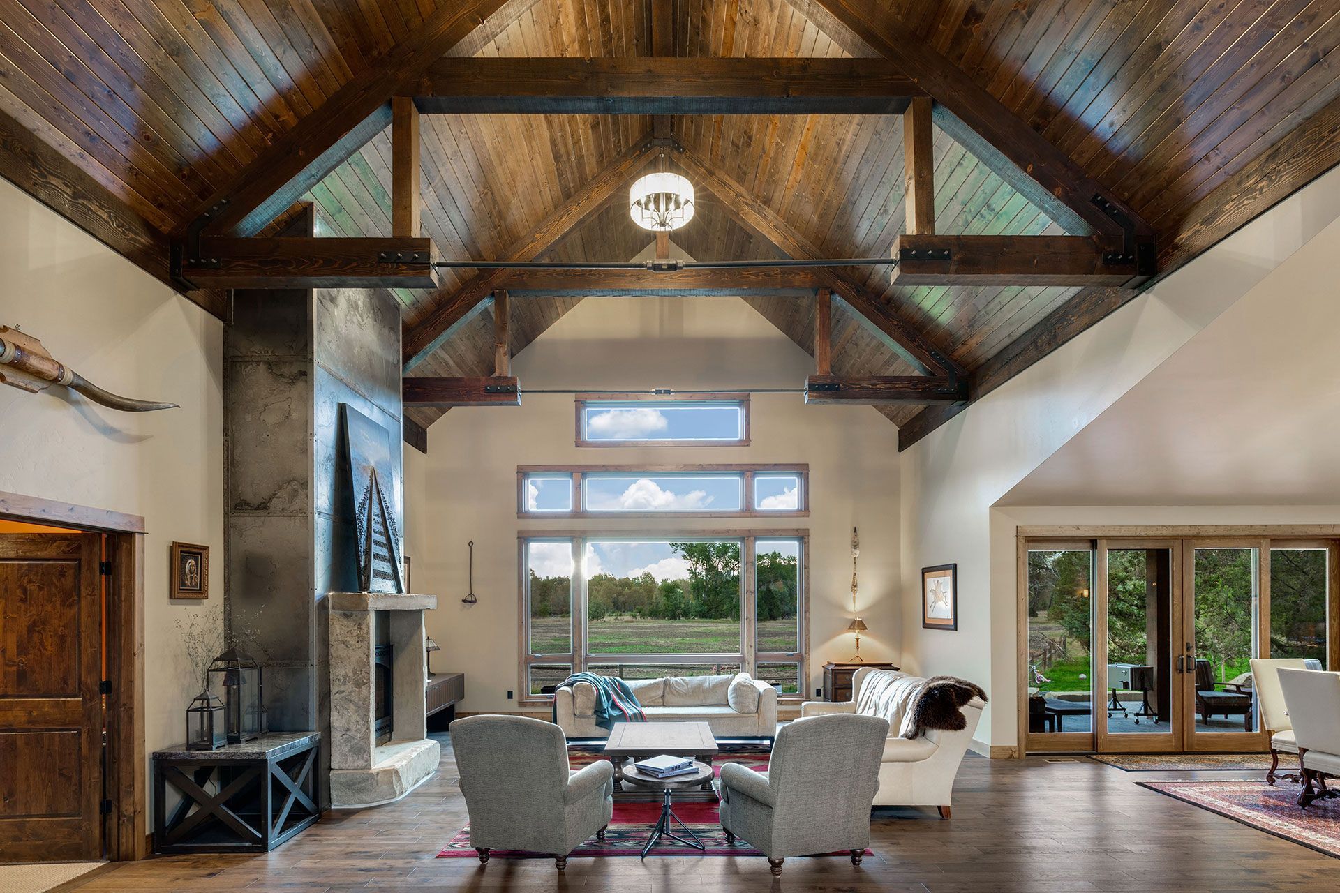 A living room with a vaulted ceiling and lots of windows