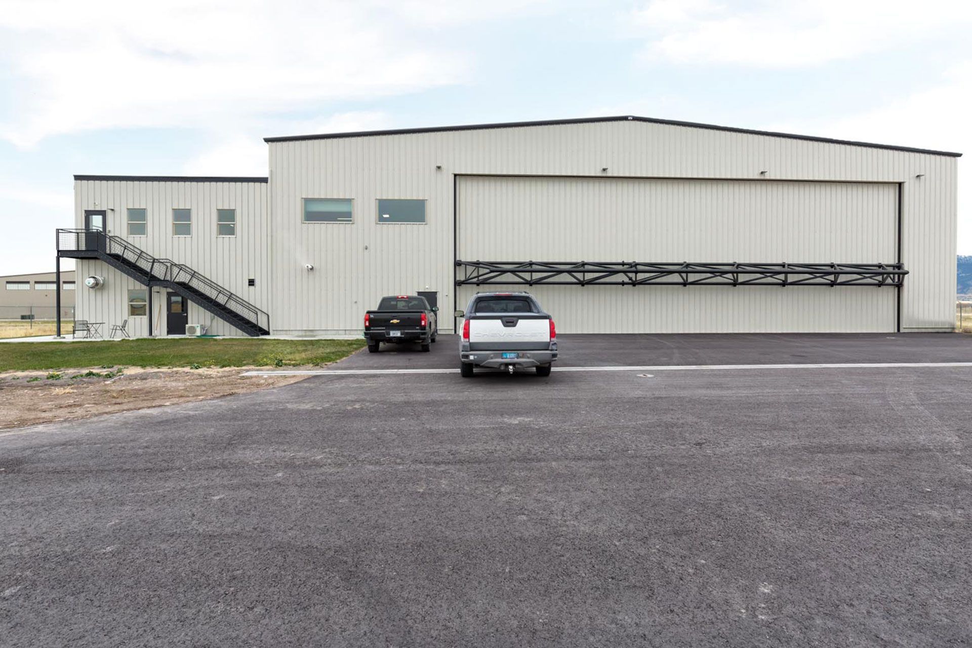 A truck is parked in front of a large building