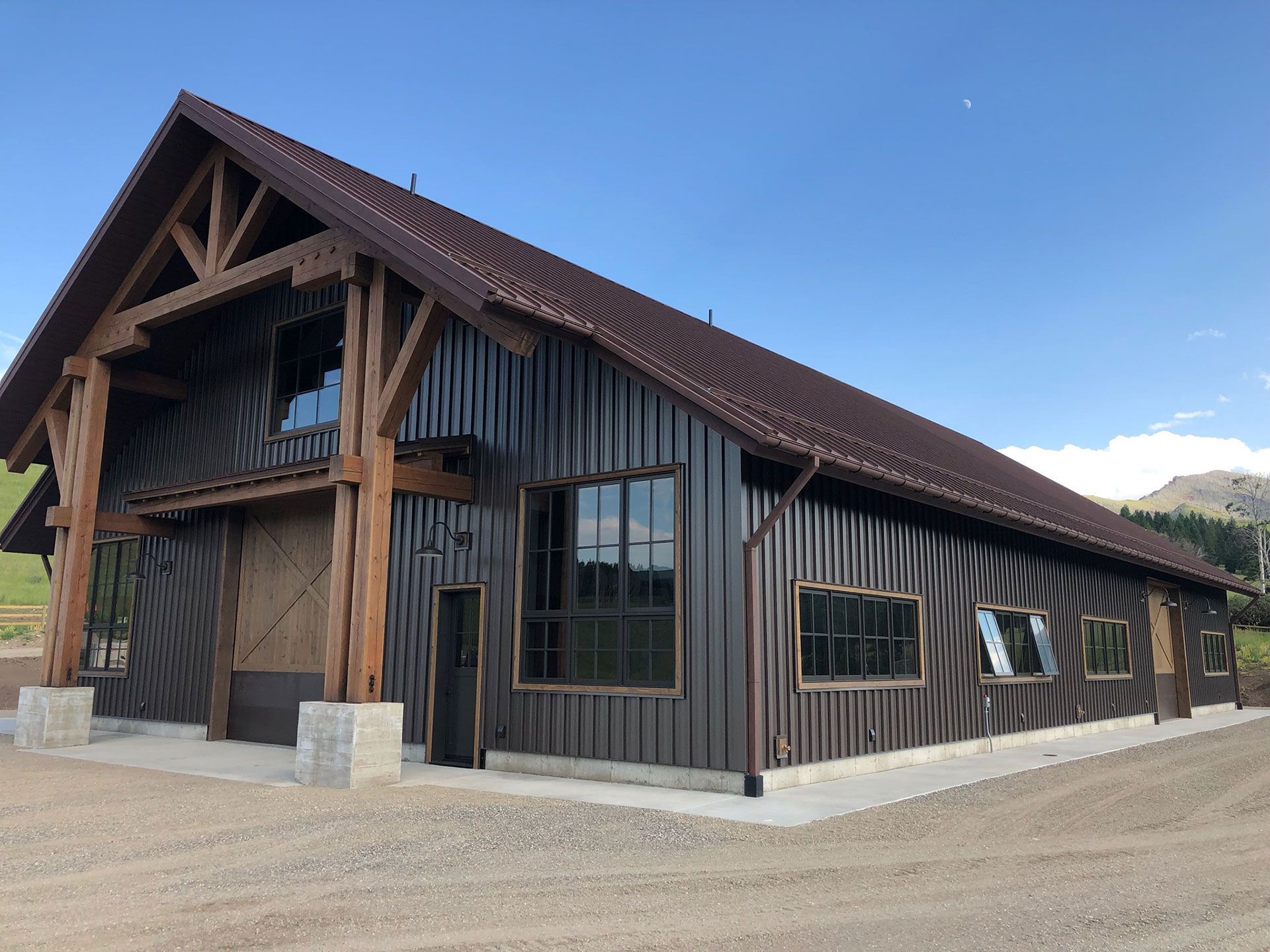 A large brown building with a wooden roof and a lot of windows