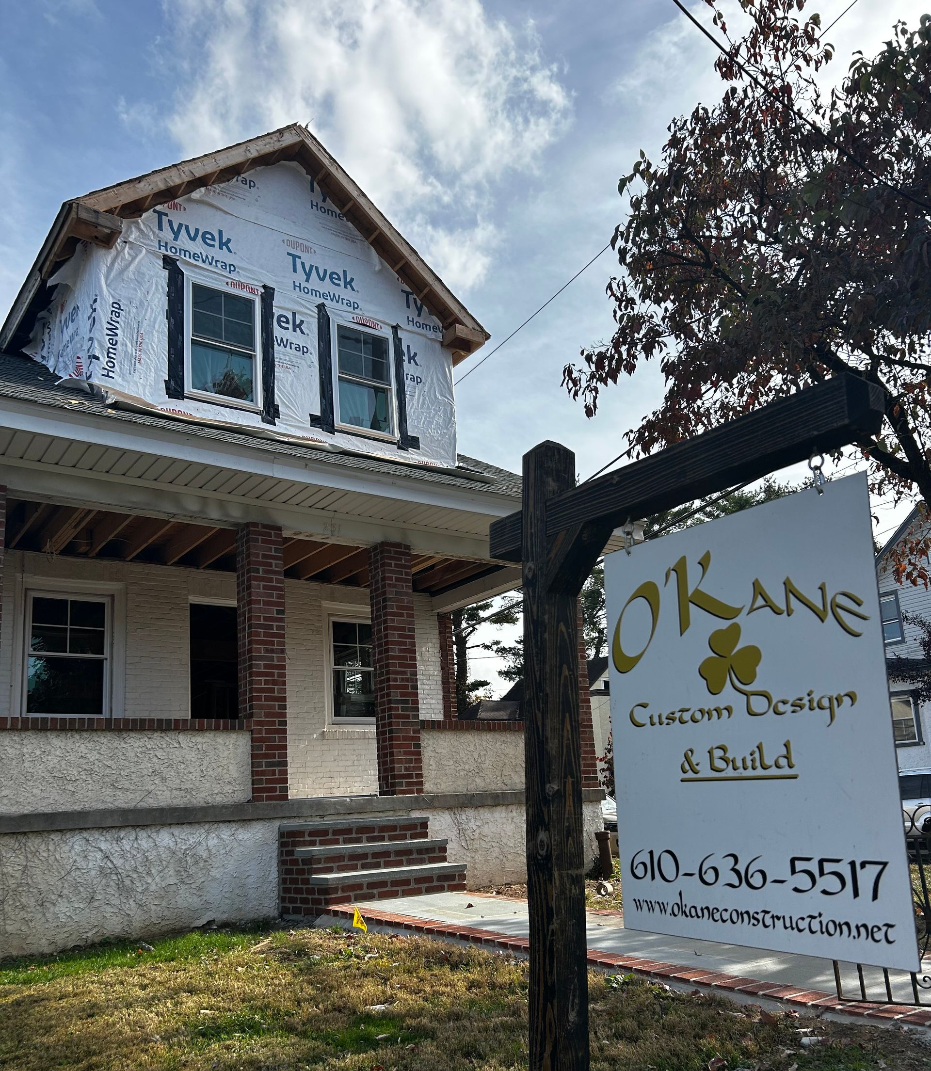 House under construction with sign for